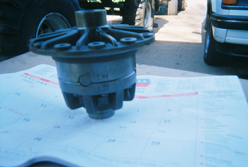 Differential part on a calendar, with a large tire and vehicle in the background