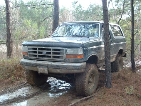 1993 Ford Bronco - This 1993 Ford Bronco is shown navigating a muddy trail in a wooded area.