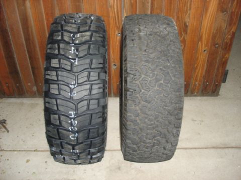 1987 Ford Bronco - Comparison of two off-road tires, one new with markings, the other used.