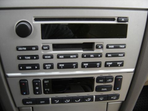 2002 Lincoln Town Car - Close-up of a car's center console, showing the audio system and climate control panel.