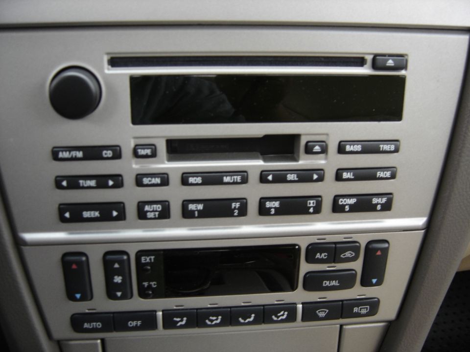 car stereo with buttons for AM/FM, CD, TAPE, SCAN, RDS, MUTE, TUNE, SEEK, AUTO SET, REW, FF, SIDE, COMP, SHUF, BASS, TREB, BAL, FADE, and climate controls with AUTO, OFF, EXT, A/C, DUAL settings