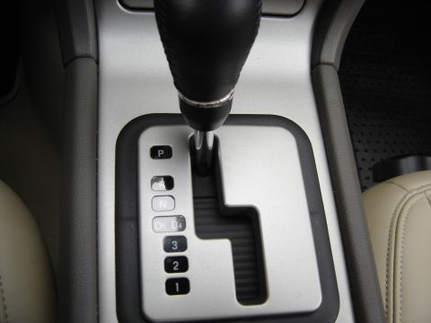 2002 Lincoln Town Car - Interior view of a car's automatic transmission shifter and console.
