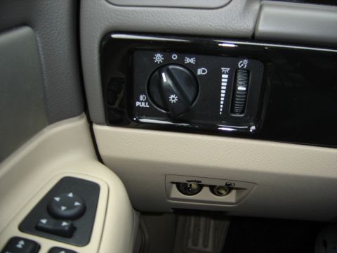 2002 Lincoln Town Car - Close-up of the dashboard reveals the light controls and auxiliary power outlets.