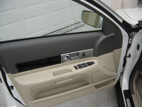 2002 Lincoln Town Car - Close-up view of the interior door panel, showing the door handle, window controls, and storage compartment.