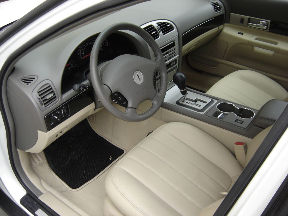 Interior view of a 2002 Lincoln Town Car showing dashboard, steering wheel, center console, and front seats