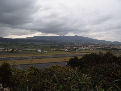 1988 Ford Bronco - A view of a town and mountains from a vantage point overlooking an airport runway.