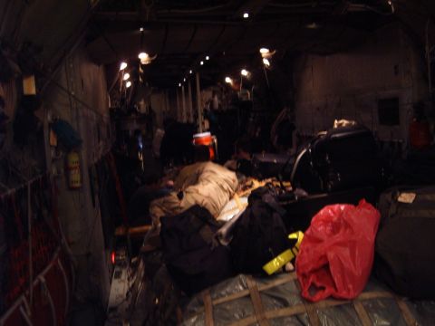 1988 Ford Bronco - Luggage and supplies are packed inside the cargo hold of an aircraft.