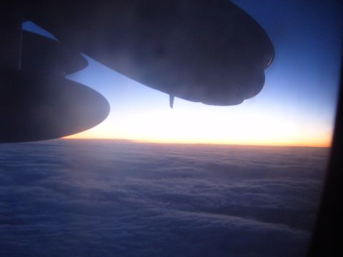 1988 Ford Bronco - View from an airplane window shows the wing and clouds during sunset.