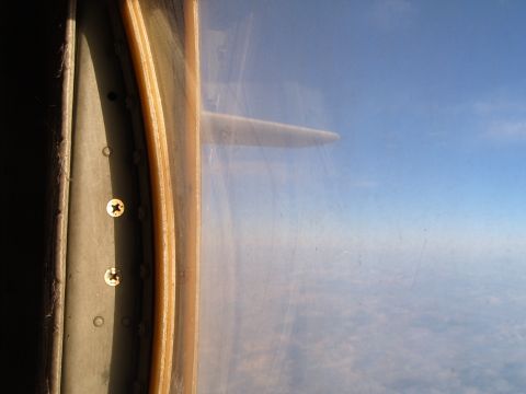1988 Ford Bronco - Airplane wing visible through the cabin window during flight.