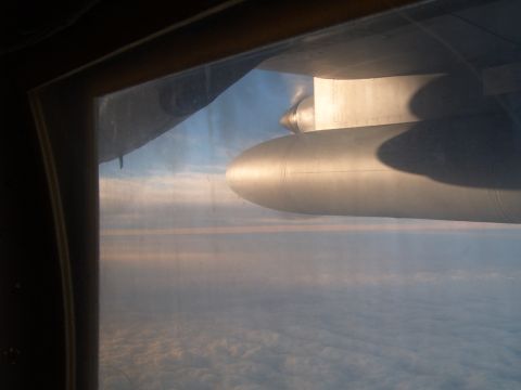 1988 Ford Bronco - Looking out the window at the clouds and an airplane engine pod.