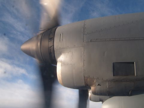 1988 Ford Bronco - Close-up of an airplane's engine nacelle and propeller in flight, with the sky visible in the background.