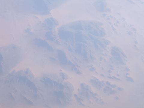 1988 Ford Bronco - This image shows a vast desert landscape viewed from high above, with hazy atmospheric conditions.