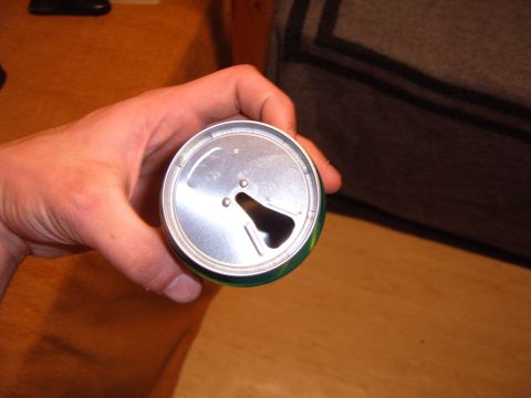 1988 Ford Bronco - An aluminum can top is held in a hand, revealing the pull tab opening.
