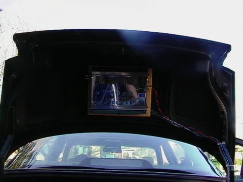 1995 Ford Contour - Aftermarket stereo installed in the trunk lid of a car.