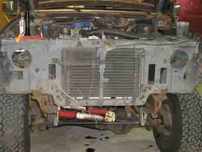 1988 Ford Bronco - The front of a vehicle is disassembled, revealing the engine bay and radiator for maintenance or repair.