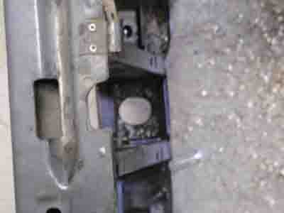 1988 Ford Bronco - Detail of a vehicle component, possibly from an engine bay, with visible metalwork and plastic housing.