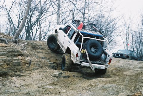 1995 Ford Bronco - Off-road vehicles tackle a challenging rocky terrain during an outdoor event.