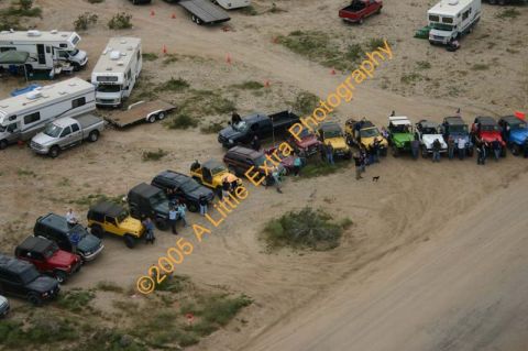 1992 Ford Bronco - A collection of Jeeps and RVs are gathered in a desert landscape.