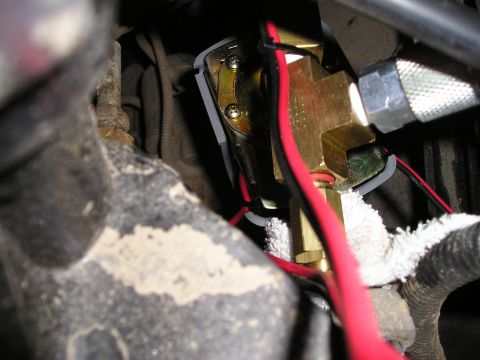 1996 Ford Bronco - Close-up of a brass on-board air compressor valve with visible wiring and a Supermotors.net watermark.
