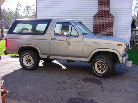 1989 Ford Bronco - This 1989 Ford Bronco is parked outside a house, showing its side profile.