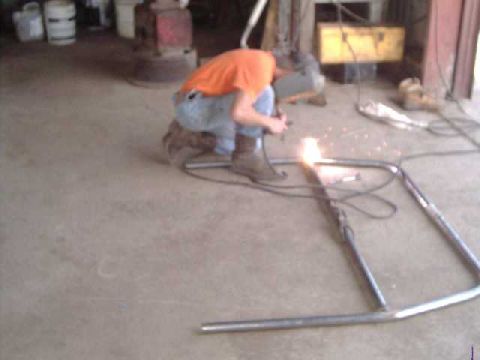 1984 Ford Bronco - Tack-welding seat crossmbr, to main hoop. The fit was real close, so done before mounting the hoop in the Bronco. This made the hoop legs d…