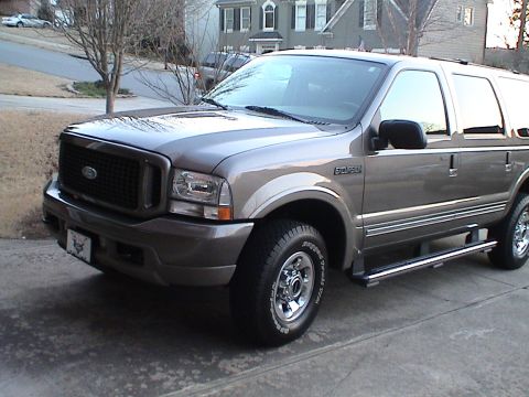 2004 Ford Excursion - This 2004 Ford Excursion SUV is seen from a three-quarter front view, parked on a residential driveway.