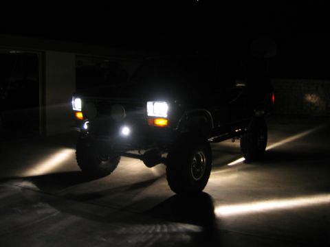 1985 Ford Bronco - This 1985 Ford Bronco is shown at night with its headlights and rock lights illuminated.