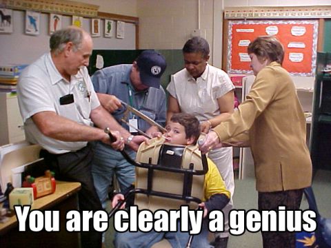 1992 Ford Bronco - A group of adults appear to be interacting with a child in a medical brace in what looks like a classroom setting.