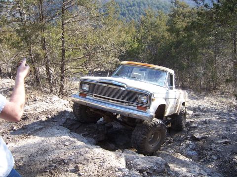 1999 Jeep TJ - Jeep pickup truck tackling a challenging off-road course.