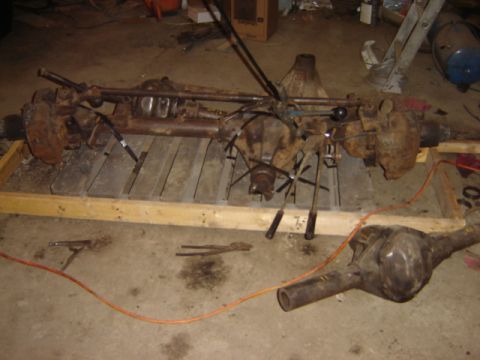 1992 Ford Bronco - Differential assemblies are shown on a wooden pallet and the concrete floor.