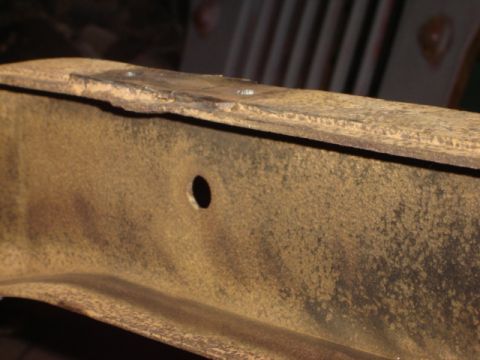 1992 Ford Bronco - A close-up shot shows a section of a rusty metal frame with a hole and a watermark for Supermotors.net.