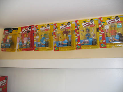 1994 Ford Crown Victoria - Several packaged Simpsons action figures are displayed on a shelf.