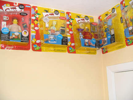 1994 Ford Crown Victoria - Several "The Simpsons" action figure playsets are displayed on a wall.