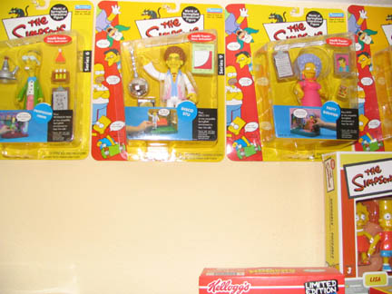 1994 Ford Crown Victoria - Collection of The Simpsons action figures displayed in their original packaging on a shelf.