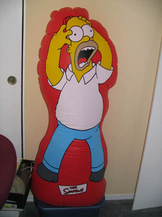 1994 Ford Crown Victoria - Inflatable Homer Simpson punching bag with 'The Simpsons' logo visible on the base.