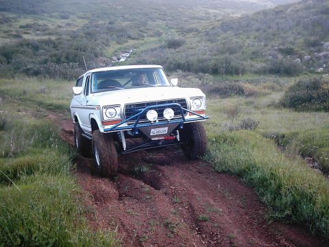 1978 Ford Bronco - This 1978 Ford Bronco navigates a off-road trail, its modified suspension and tires.