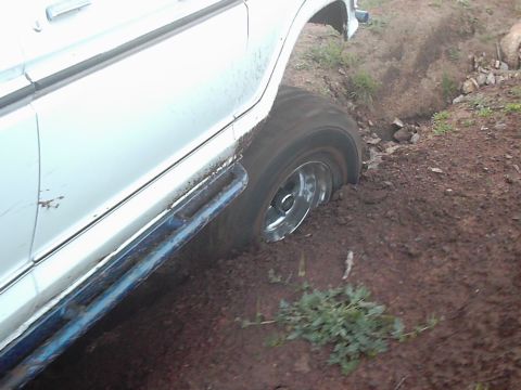 1978 Ford Bronco - This 1978 Ford Bronco is stuck in the mud, with its side and front wheel partially submerged.