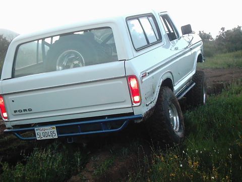 1978 Ford Bronco - This 1978 Ford Bronco is navigating a muddy trail with its rear facing the camera.