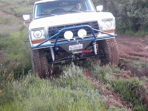1978 Ford Bronco - This modified 1978 Ford Bronco navigates a dirt trail, its off-road capabilities.