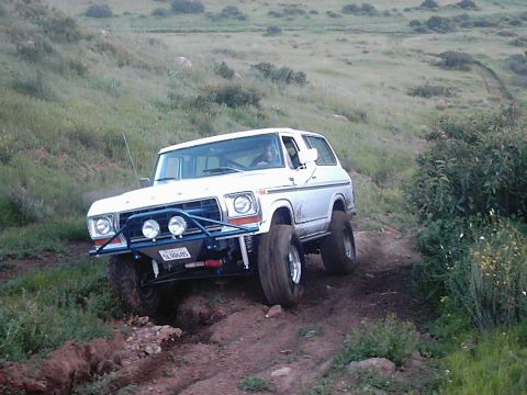 1978 Ford Bronco - This 1978 Ford Bronco navigates a steep, dusty trail with its front wheels angled to the right.