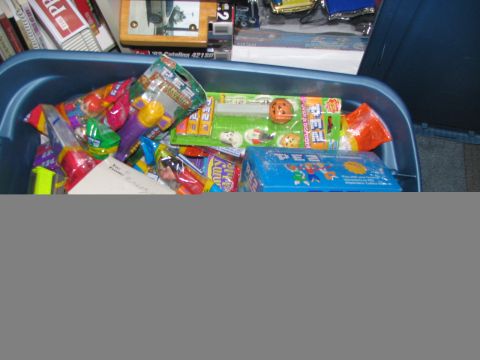1994 Ford Crown Victoria - A collection of Pez dispensers and candy is stored in a blue plastic bin.