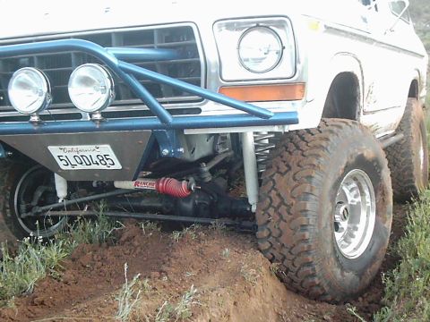 1978 Ford Bronco - This modified Ford Bronco features a custom front bumper, roll cage, and large tires, suggesting off-road use.