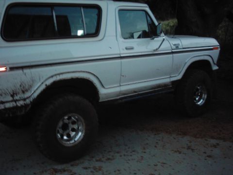 1978 Ford Bronco - 1978 Ford Bronco seen from the side, showing its body style and aftermarket wheels.