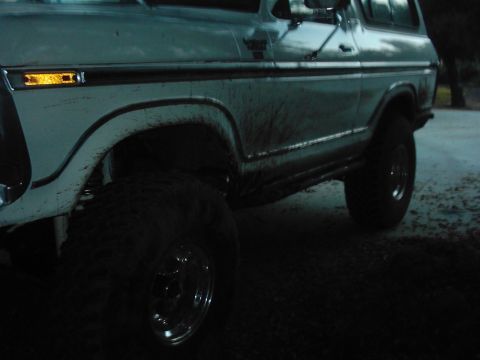1978 Ford Bronco - This 1978 Ford Bronco is shown from the front quarter angle, covered in mud from off-roading.