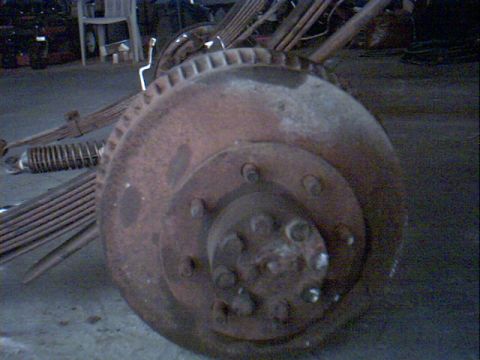 1990 Ford Bronco - This is a close-up of a rusty brake rotor and associated suspension components.