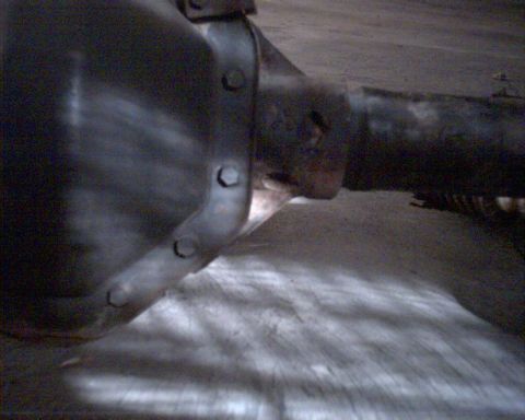 1990 Ford Bronco - Close-up view of a rear axle differential housing, showing the bolted cover and axle tube. The 'Supermotors' watermark is visible at the bo…