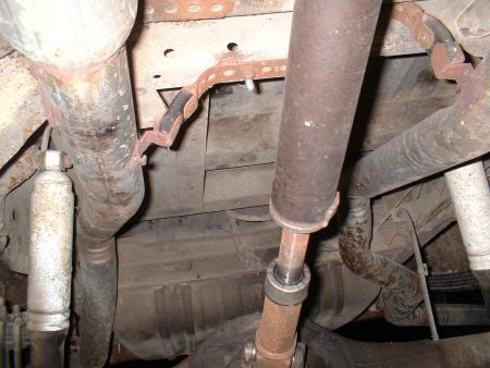 1978 Ford Bronco - The underside of a vehicle shows exhaust components and suspension parts.