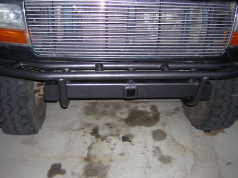 1995 Ford Bronco - Front view of a black Ford Bronco, showing its custom bumper and grille.