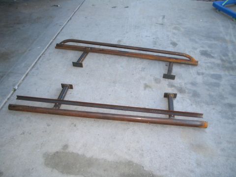 1991 Ford Bronco - Two custom metal side steps are shown resting on a concrete surface.