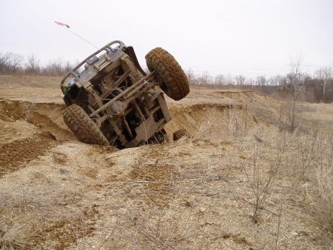 1992 Ford Bronco - An off-road vehicle has become stuck and overturned in a sandy ditch.